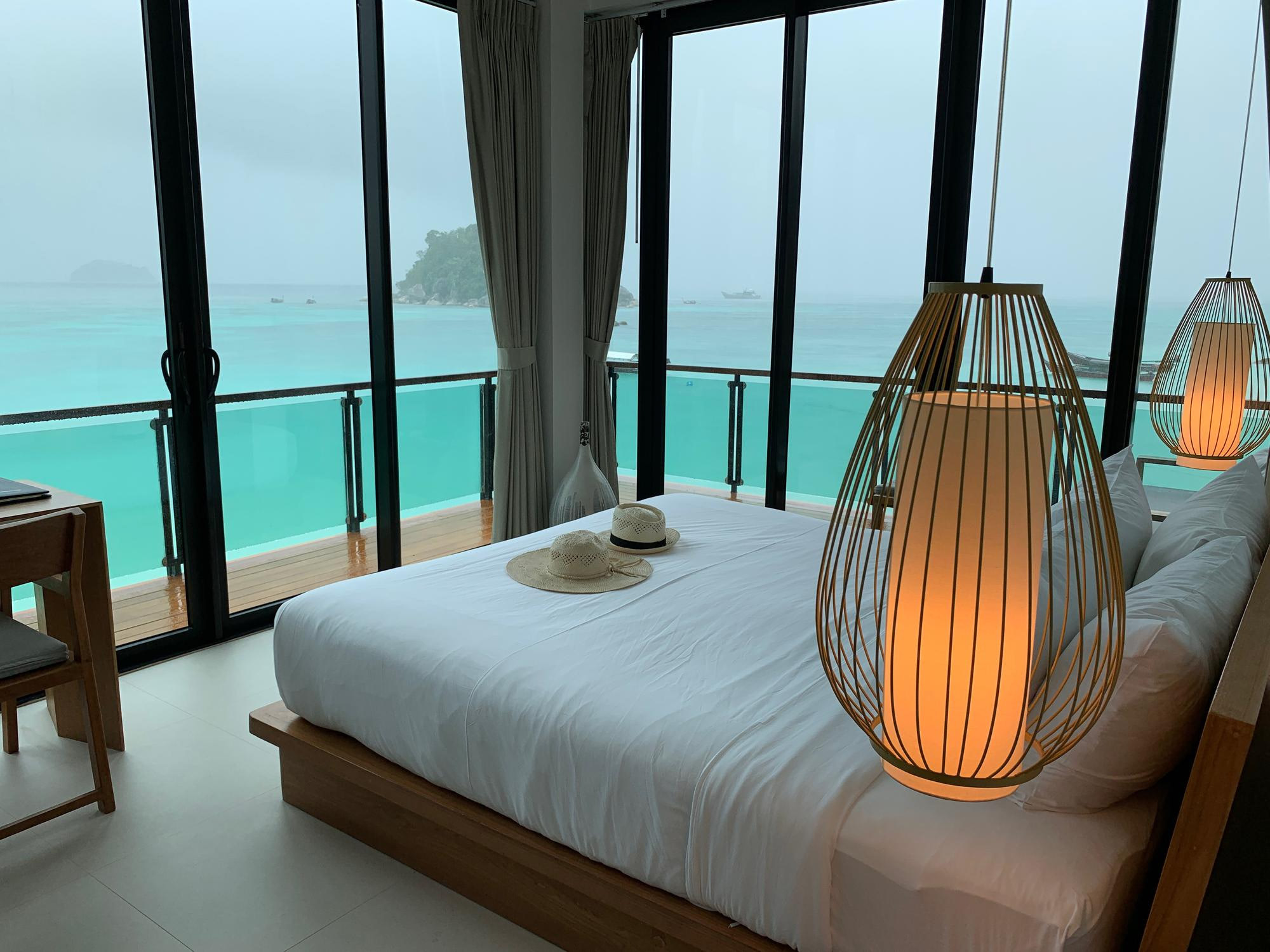 Ocean view bedroom with a rattan lamp