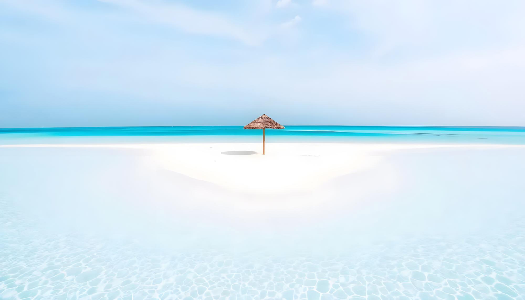White sandbank with a single umbrella